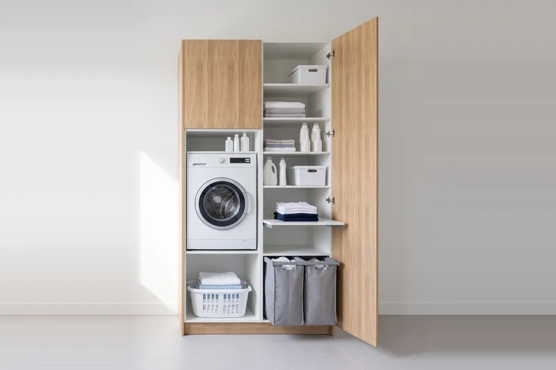 Impressie: wasmachinekast met een kast, 128,7 cm breed en 250 cm hoog, fronten in naturel eiken, met deuren open.