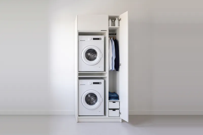Impressie: wasmachinekast met een kast, 103,7 cm breed en 250 cm hoog, fronten in wit, met deuren open.
