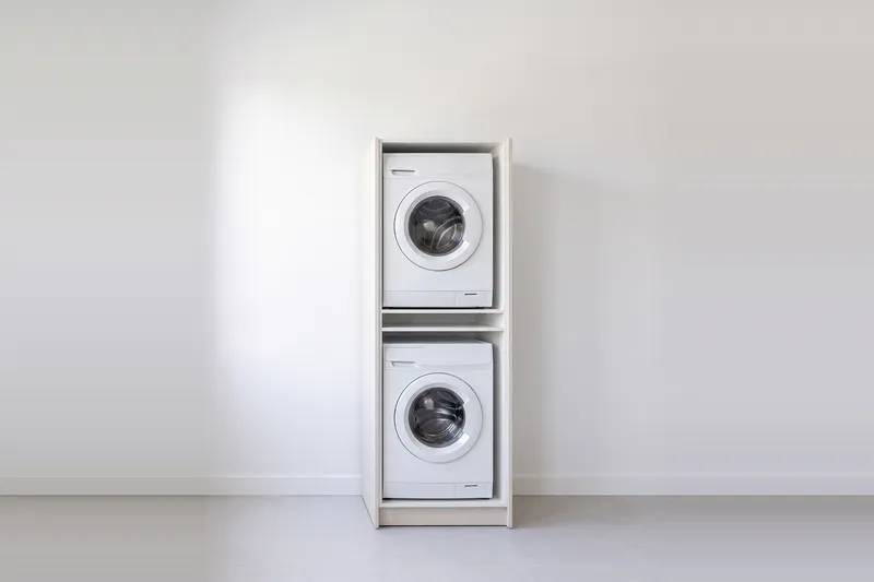 Impressie: wasmachinekast, 73,6 cm breed en 210 cm hoog, fronten in structuur, met deuren open.